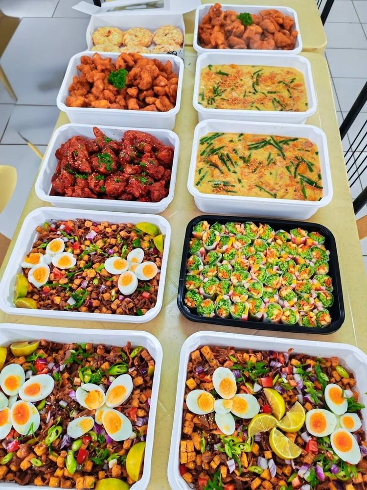 Trays of pancit, chicken and salad